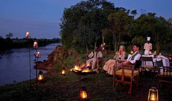 Candlelit riverside dinner at a safari lodge